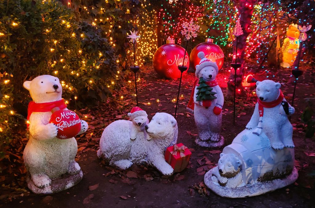 Group of ice bear figurines with santa hats and merry christmas message