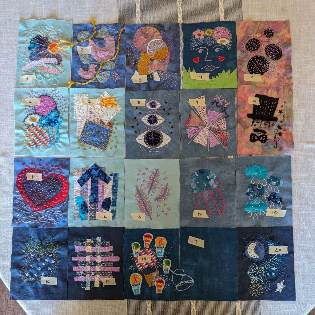 24 stitched pages on a tabletop.